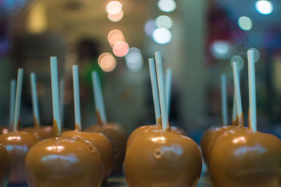 Close-up of illuminated candles on table