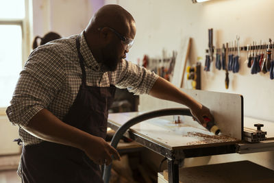 Rear view of man working in workshop
