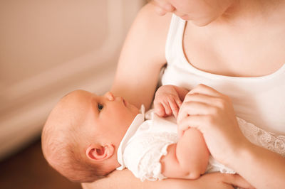 Midsection of woman holding baby