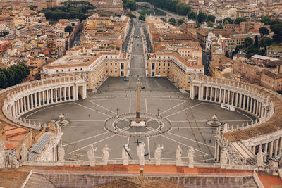 Aerial view of statue amidst buildings in city