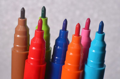 Close-up of multi colored bottles on table