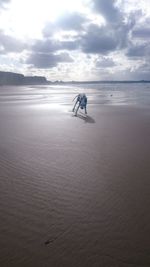 Man on beach against sky