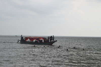 Boat sailing in sea against sky