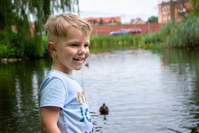 Small boy playing on a pond