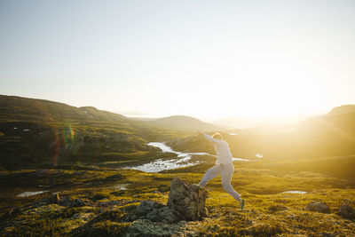 Hiker jumping on rock