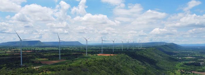 Wind turbine farm power generator in beautiful nature landscape for production of renewable