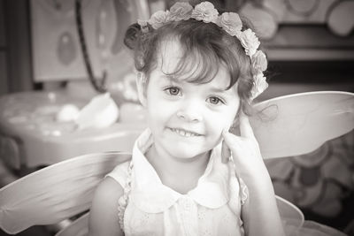 Portrait of smiling girl wearing angel costume