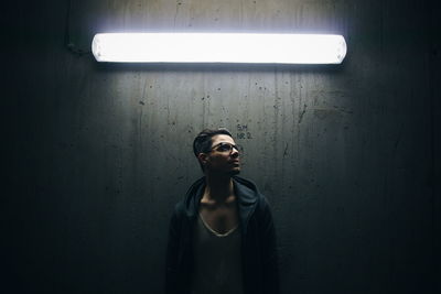 Portrait of woman standing on wall