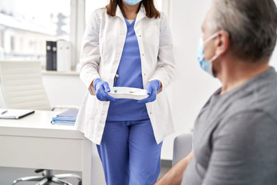 Side view of doctor examining patient in hospital