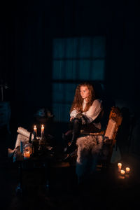 Man sitting on seat in illuminated room