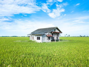 House on field against sky