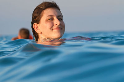 Portrait of young man swimming in pool