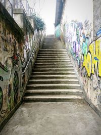 Steps amidst multi colored trees against sky