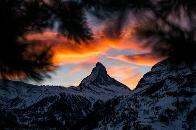 Scenic view of snowcapped mountains against sky during sunset