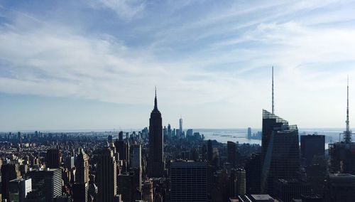 View of cityscape against cloudy sky