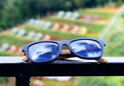 Close-up of sunglasses on railing