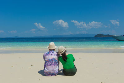 Rear view of beach against sky