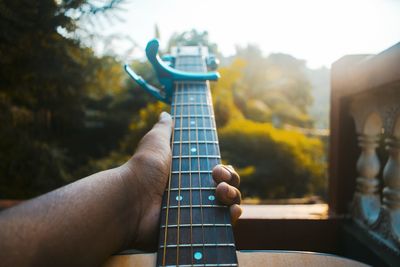 Midsection of person playing guitar