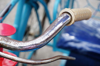 Close-up of metal railing against blue water