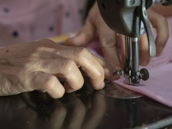 Midsection of man working at machine