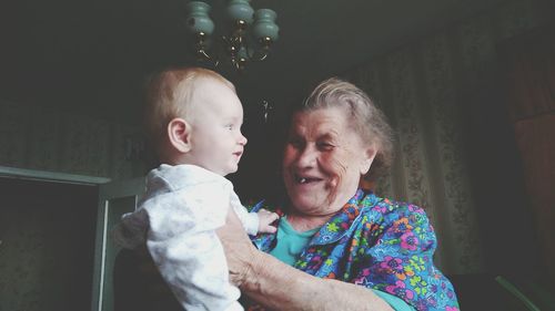 Low angle view of happy grandmother looking at grandson