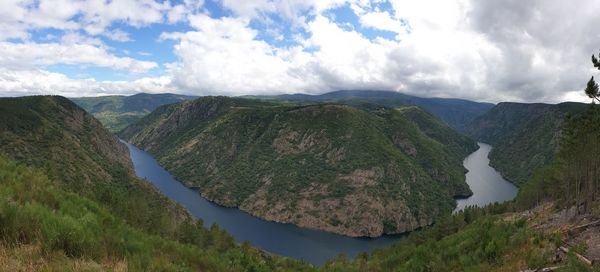 Panoramic view of river and mountains against sky