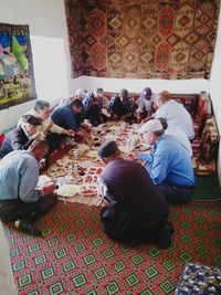 Rear view of people sitting at table