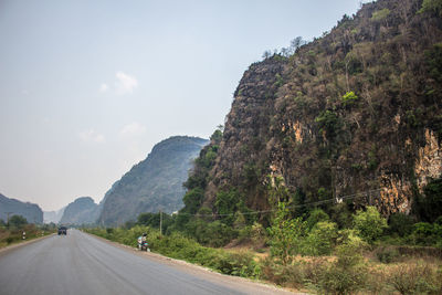 Empty road leading towards mountains