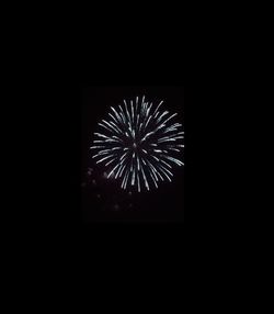 Low angle view of firework display at night