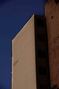 Low angle view of building against clear blue sky