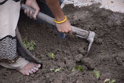 Low section of woman working in farm