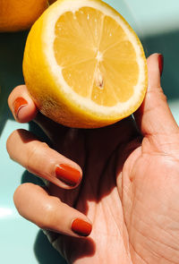 Close-up of hand holding lemon