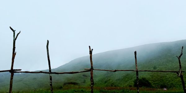 Fence on mountain against sky