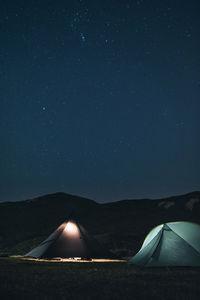 Scenic view of tent against sky at night