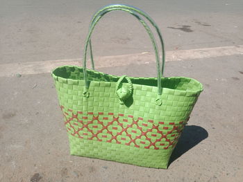 High angle view of green chili peppers in basket