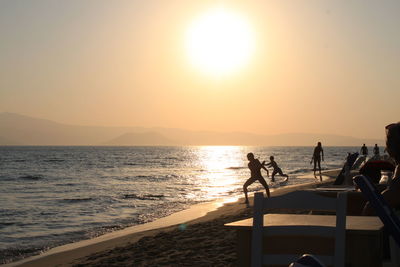 Silhouette of people on beach during sunset