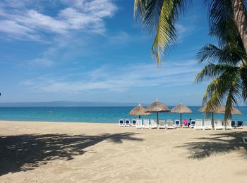 Scenic view of beach against blue sky