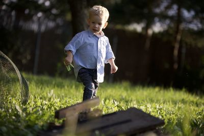 Portrait of boy standing on field