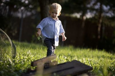 Portrait of boy standing on field