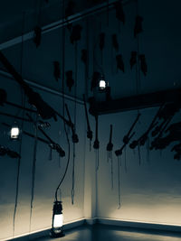 Low angle view of illuminated lights against sky at night