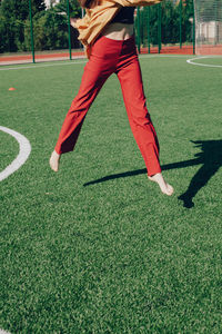 Low section of man playing soccer on field