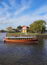 Building by river against sky