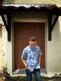 Full length of man standing in front of building