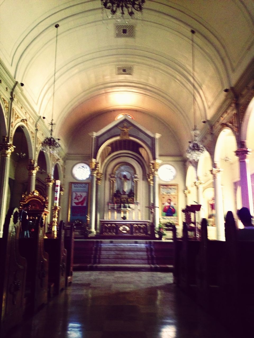 indoors, arch, architecture, ceiling, built structure, corridor, interior, architectural column, empty, flooring, place of worship, the way forward, religion, in a row, pew, column, illuminated, church, archway