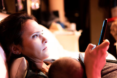 Portrait of woman holding mobile phone