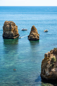 Rocks in sea against sky