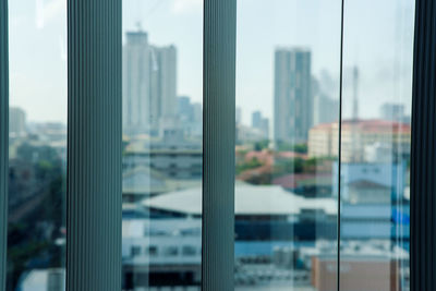 Close-up of cityscape seen through glass window