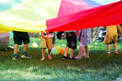 Low section of children playing on grass