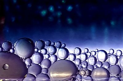 Close-up of bubbles against blue background