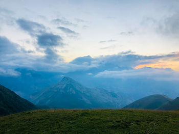 Scenic view of mountains against cloudy sky